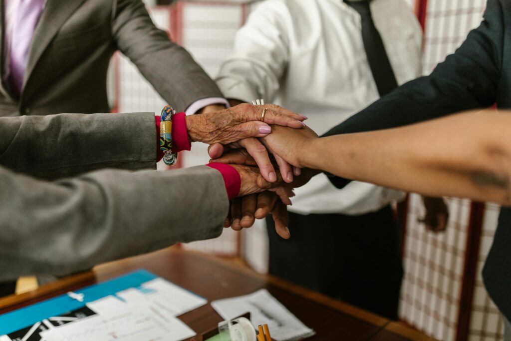 Home A diverse group of businesspeople uniting their hands symbolizing teamwork and cooperation.